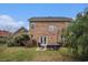 Spacious backyard featuring a brick home exterior, outdoor seating area, and well-maintained lawn at 3605 Kingsley Dr., Myrtle Beach, SC 29588