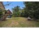 Expansive backyard with mature trees, green grass, hammock, and a patio seating area, perfect for outdoor living at 3605 Kingsley Dr., Myrtle Beach, SC 29588