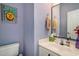 Bathroom with light blue walls, pineapple art, and a white sink at 3605 Kingsley Dr., Myrtle Beach, SC 29588