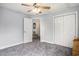 Bright bedroom with an open doorway, large closet, ceiling fan, and neutral walls at 3605 Kingsley Dr., Myrtle Beach, SC 29588