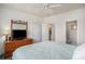 Bright bedroom with ensuite bathroom features carpet, ceiling fan, and a big bed at 3605 Kingsley Dr., Myrtle Beach, SC 29588
