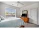 Bright bedroom featuring a ceiling fan, plush carpet, and natural light from a large window at 3605 Kingsley Dr., Myrtle Beach, SC 29588