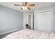 Bright bedroom featuring neutral walls, a ceiling fan, closet, and a connecting door at 3605 Kingsley Dr., Myrtle Beach, SC 29588