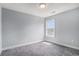 Neutral colored bedroom features a single window, carpeted floor, and a ceiling light at 3605 Kingsley Dr., Myrtle Beach, SC 29588