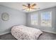 A cozy bedroom with a ceiling fan and natural light from dual windows at 3605 Kingsley Dr., Myrtle Beach, SC 29588