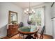 Bright dining area features hardwood floors, a chandelier, and views of the landscaped backyard at 3605 Kingsley Dr., Myrtle Beach, SC 29588