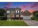 Exterior view of a two-story home at dusk with brick and vinyl siding at 3605 Kingsley Dr., Myrtle Beach, SC 29588