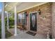 Charming front porch with brick columns and a decorative door at 3605 Kingsley Dr., Myrtle Beach, SC 29588