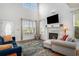 Bright living room featuring vaulted ceiling, fireplace, and large windows at 3605 Kingsley Dr., Myrtle Beach, SC 29588