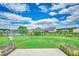 Expansive backyard with lush grass, black fencing, and serene pond in a peaceful community at 364 Copperwood Loop, Conway, SC 29526