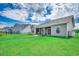 Lush green backyard showcasing the home's exterior, manicured lawn, and peaceful neighborhood setting at 364 Copperwood Loop, Conway, SC 29526