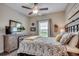 Comfortable bedroom with neutral tones, a ceiling fan, and a large window providing natural light at 364 Copperwood Loop, Conway, SC 29526