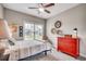 Well-lit bedroom with a decorative clock, neutral tones, and a large window providing natural light at 364 Copperwood Loop, Conway, SC 29526