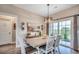 Bright dining room featuring stylish chandelier, sliding glass doors, and decor elements at 364 Copperwood Loop, Conway, SC 29526
