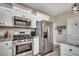 Close-up of a well-equipped kitchen with stainless steel appliances and sleek, white cabinetry at 364 Copperwood Loop, Conway, SC 29526
