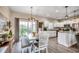 Open-concept kitchen and dining area with white cabinetry, stainless steel appliances, and large sliding doors at 364 Copperwood Loop, Conway, SC 29526