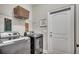 Functional laundry room with modern appliances, storage shelves, and access to an exterior door at 364 Copperwood Loop, Conway, SC 29526