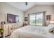 Spacious main bedroom featuring vaulted ceilings, a ceiling fan, and a large window with backyard views at 364 Copperwood Loop, Conway, SC 29526