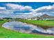 Community pond reflecting blue skies and clouds, surrounded by well-maintained lawns and homes at 364 Copperwood Loop, Conway, SC 29526