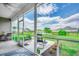 Relaxing screened porch with chairs overlooking the landscaped backyard and tranquil pond views at 364 Copperwood Loop, Conway, SC 29526