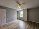 Spacious bedroom with a ceiling fan, light-colored walls, and wood-look flooring, offering a serene and modern atmosphere at 3786 Hitchcock Way # 321, Myrtle Beach, SC 29577