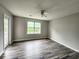 Bright bedroom with wood-look floors, with a ceiling fan, window and a door to the deck for relaxing at 3786 Hitchcock Way # 321, Myrtle Beach, SC 29577