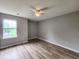 Bright bedroom featuring a ceiling fan, a large window, and wood-look flooring for a clean, contemporary feel at 3786 Hitchcock Way # 321, Myrtle Beach, SC 29577
