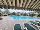 A beautiful community pool is sheltered by awning and surrounded by lounge chairs and manicured landscape at 3786 Hitchcock Way # 321, Myrtle Beach, SC 29577