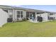 Well-maintained backyard with green lawn, patio with seating and grill, enclosed by white fence at 4027 Taranto Loop # C, Myrtle Beach, SC 29579