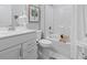 Well-lit bathroom featuring a single sink vanity and a tub with white tiled walls at 4027 Taranto Loop # C, Myrtle Beach, SC 29579