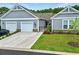 Charming home featuring a two-car garage, manicured lawn, and inviting facade at 4027 Taranto Loop # C, Myrtle Beach, SC 29579