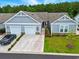Modern home featuring a three-car garage, well-manicured lawn, and inviting walkway at 4027 Taranto Loop # C, Myrtle Beach, SC 29579