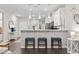 Open-concept kitchen with white countertops, blue stools, and modern lighting fixtures at 4027 Taranto Loop # C, Myrtle Beach, SC 29579
