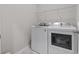 Bright laundry room featuring a white front-loading washer and dryer with wire shelving at 4027 Taranto Loop # C, Myrtle Beach, SC 29579