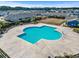 Aerial view of a clover-shaped pool with lounge area and nearby community homes, perfect for recreation at 4027 Taranto Loop # C, Myrtle Beach, SC 29579