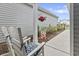 Relaxing porch seating with decorative floral arrangements and a charming water feature at 4027 Taranto Loop # C, Myrtle Beach, SC 29579