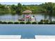 Scenic view of a well-maintained backyard featuring a boat dock and lift on the serene waterfront at 4110 Gray Heron Dr., North Myrtle Beach, SC 29582