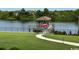Scenic view of a well-maintained backyard featuring a boat dock and lift on the serene waterfront at 4110 Gray Heron Dr., North Myrtle Beach, SC 29582