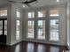 Bright living room features dark wood flooring and tall windows which provide plenty of natural light at 4110 Gray Heron Dr., North Myrtle Beach, SC 29582