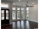 Bright living room features dark wood flooring and tall windows which provide plenty of natural light at 4110 Gray Heron Dr., North Myrtle Beach, SC 29582