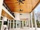 Expansive patio features high ceilings, wood accents, ceiling fans, and stately columns creating a luxurious outdoor living space at 4110 Gray Heron Dr., North Myrtle Beach, SC 29582