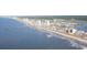 Stunning aerial view of the coastline featuring beaches, a pier, hotels, and residential homes at 437 Falling Leaf Loop, Myrtle Beach, SC 29588