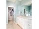 Bathroom boasts a granite-topped, double-sink vanity and a walk-in closet for accessible and convenient storage at 437 Falling Leaf Loop, Myrtle Beach, SC 29588