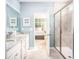 Bright bathroom with double sinks, granite counters, framed mirrors, and a walk-in shower with glass enclosure at 437 Falling Leaf Loop, Myrtle Beach, SC 29588