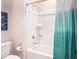 Clean, white bathroom features a tub with shower, toilet, and decorative accents at 437 Falling Leaf Loop, Myrtle Beach, SC 29588