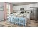 Bright kitchen featuring white cabinets, granite countertops, stainless steel appliances, and a central island with seating at 437 Falling Leaf Loop, Myrtle Beach, SC 29588