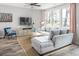 Cozy living room featuring a comfortable sectional sofa, a TV, and lots of natural light at 437 Falling Leaf Loop, Myrtle Beach, SC 29588