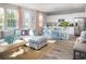 Open-concept living area featuring a kitchen with island, a comfortable sectional, and natural light at 437 Falling Leaf Loop, Myrtle Beach, SC 29588