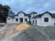 Contemporary home featuring a stucco facade, black-trimmed windows, and gabled roof, showcasing modern design at 4300 Gray Heron Dr., North Myrtle Beach, SC 29582