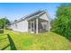 Exterior view of a well-maintained home featuring a screened porch and a lush green lawn, perfect for outdoor enjoyment at 4363 Bayshore Dr., Little River, SC 29566